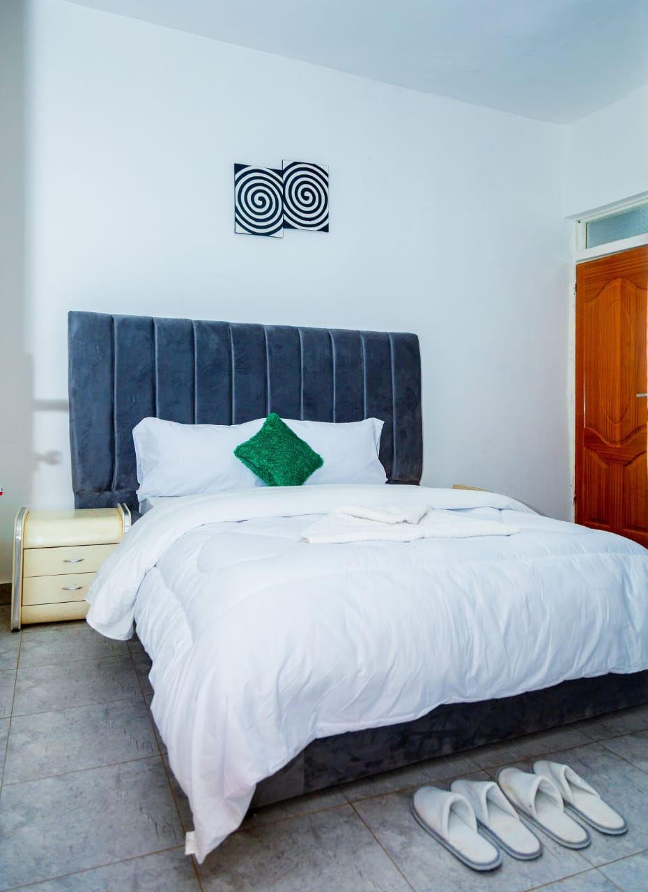 Bedroom with grey headboard and green pillow
