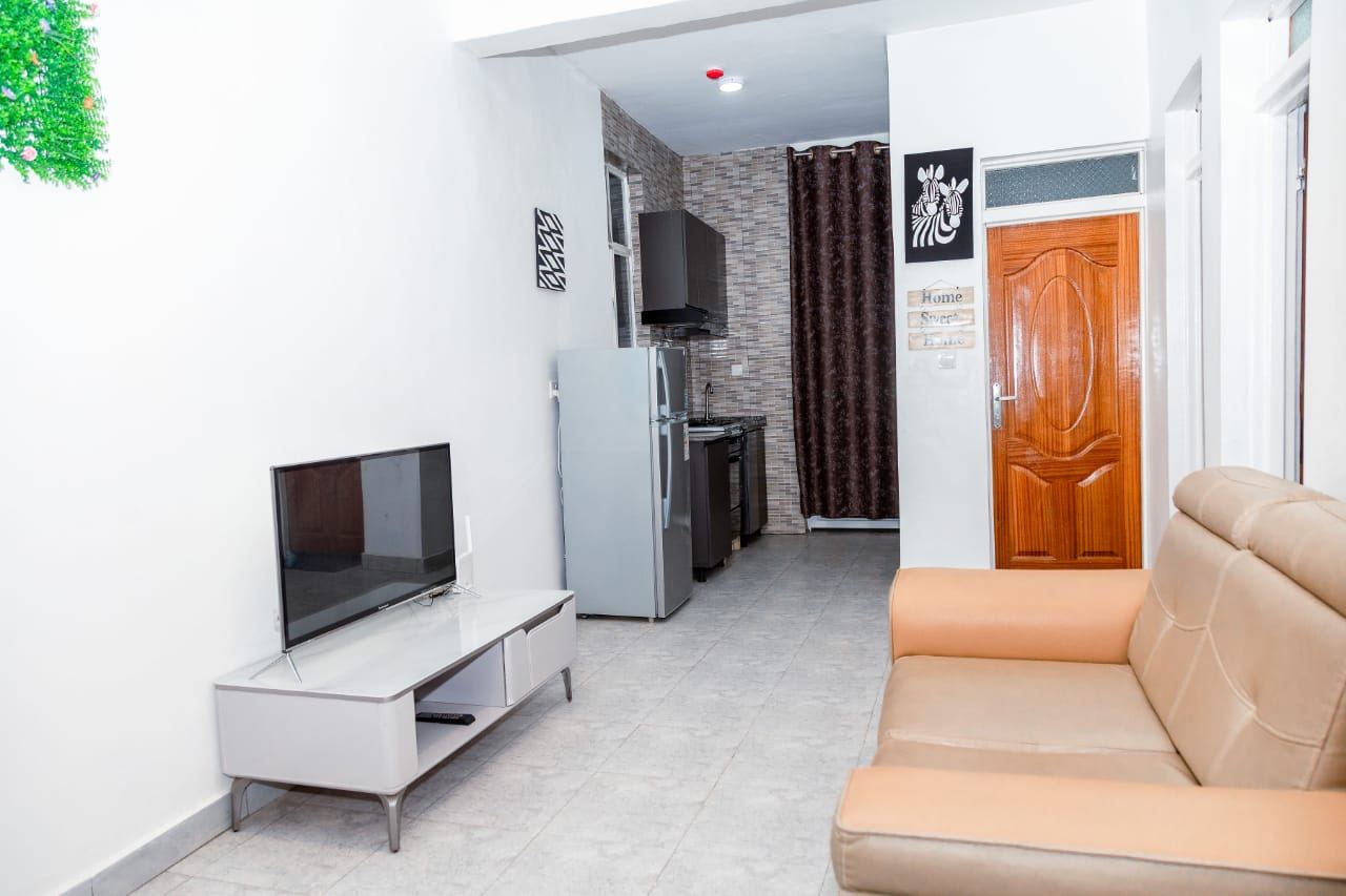 Living room with TV and kitchen view